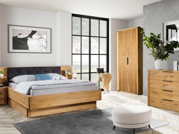 Drewniane łóżko z wysokim zagłówkiem w jasnym wnętrzu