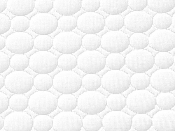 Zbliżenie pokrowca materaca z delikatną strukturą plaster miodu