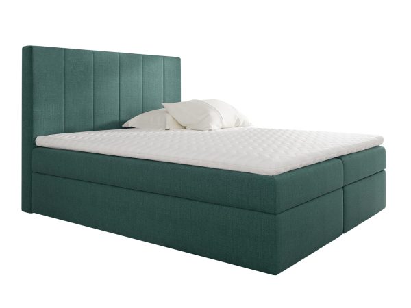 Turkusowe łóżko z wyrazistym zagłówkiem i ozdobną narzutą