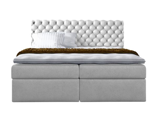 Białe łóżko z efektownym pikowaniem i jasną tapicerką