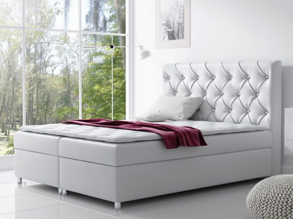 Białe łóżko z połyskiem i miękkim wezgłowiem