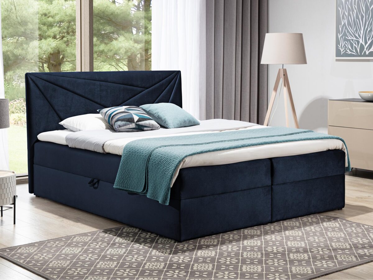 Granatowe łóżko tapicerowane z przeszywanym zagłówkiem do nowoczesnej sypialni