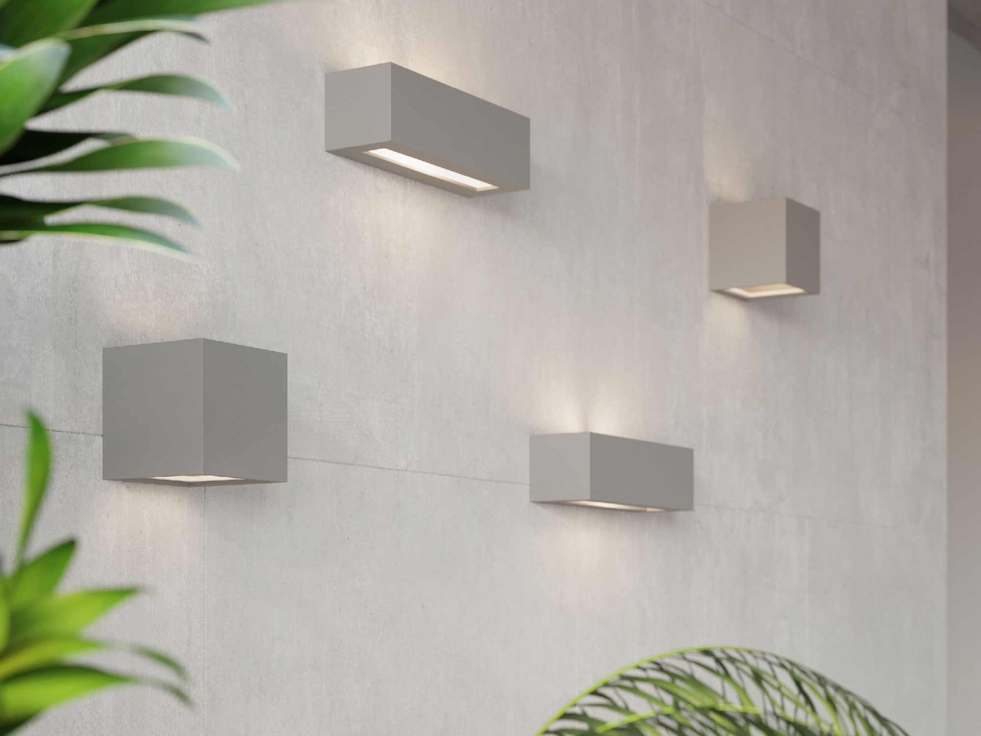 Biały kinkiet LED w kształcie prostopadłościanu w jasnym wnętrzu Biały kinkiet LED w kształcie prostopadłościanu w jasnym wnętrzu