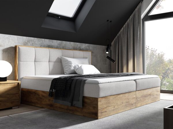 Jasnoszare łóżko z wysokim zagłówkiem i przeszyciami