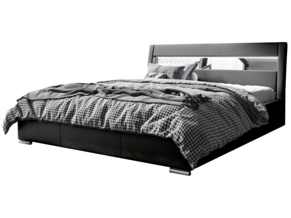 Czarno-białe łóżko z tapicerowanym zagłówkiem i geometryczną pościelą