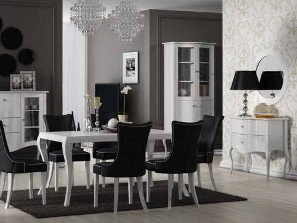 Aranżacja jadalni z białym stołem i czarnymi krzesłami w stylu glamour.