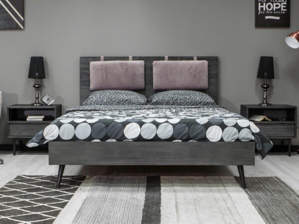 Sypialnia loftowa z czarnym łóżkiem i geometryczną pościelą